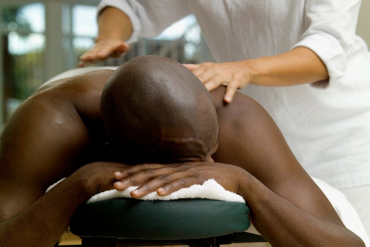 A person getting a massage from a masseuse